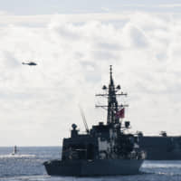 The Maritime Self-Defense Force Izumo helicopter carrier and the Murasame destroyer participate in joint multi-nation exercises in the Indo-Pacific region on May 21. | COMMANDER, TASK FORCE 70 / CARRIER STRIKE GROUP 5