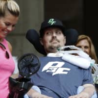Pete Frates, who inspired the ice bucket challenge, looks at his wife, Julie, during a ceremony at City Hall in Boston by Boston Mayor Marty Walsh declaring the day the Pete Frates Day in 2017. Frates, who was stricken with amyotrophic lateral sclerosis, or ALS, died Monday. He was 34. | AP