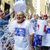 Major League Baseball Commissioner-elect Rob Manfred participates in the ALS Ice-Bucket Challenge outside the organization\'s headquarters in New York in 2014. | AP