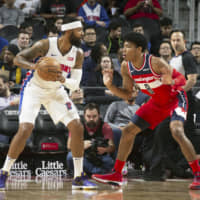 Wizards forward Rui Hachimura (right) guards the Pistons\' Markieff Morris during a game on Dec. 16 in Detroit. Hachimura was injured later in the contest. | KYODO