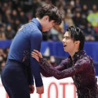 Shoma Uno (left) is congratulated by Yuzuru Hanyu after winning the men\'s competition of the Japan Championships on Sunday in Tokyo. | KYODO