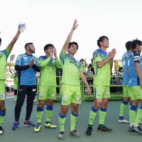 Shonan Bellmare players salute the team\'s fans after Saturday\'s match against Tokushima Vortis at BMW Stadium in Hiratsuka, Kanagawa Prefecture. The promotion-relegation playoff final ended in a 1-1 draw, and Bellmare will remain in J1 next season. | KYODO