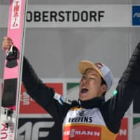 Ryoyu Kobayashi celebrates during the winner\'s ceremony after the Four Hills Tournament opener in Oberstdorf, Germany, on Sunday. | AFP-JIJI
