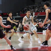 Fukuoka Daiichi point guard Yuki Kawamura dribbles in traffic against Fukuoka University Ohori during the All-Japan High School Tournament final on Sunday in Tokyo. | KAZ NAGATSUKA