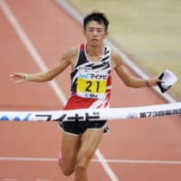 Taku Fujimoto crosses the finish line at the Fukuoka International Marathon on Sunday, in Fukuoka. Fujimoto was the fastest Japanese runner at 2 hours, 9 minutes and 36 seconds, finishing just over two minutes behind Moroccan El Mahjoub Dazza. | KYODO