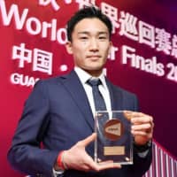 Kento Momota poses for a photo after being named the Badminton World Federation\'s Male Player of the Year during an awards ceremony in Guangzhou, China, on Monday. | KYODO
