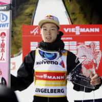 Ryoyu Kobayashi holds his trophy after winning a World Cup event on Sunday in Engelberg, Switzerland. Kobayashi is the overall World Cup leader. | REUTERS