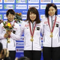 Sisters Nana (left) and Miho Takagi and Ayano Sato celebrate after winning the women\'s team pursuit at the ISU World Cup in Nagano on Sunday. | KYODO