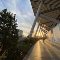 The sun sets behind the Kengo Kuma-designed National Stadium in Tokyo\'s Shinjuku Ward. | KAZUHIRO KOBAYASHI