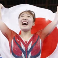 Hikaru Mori celebrates after winning the women\'s individual competition at the trampoline gymnastics world championships on Sunday at Ariake Gymnastics Centre. The achievement earned Mori a berth in next summer\'s Tokyo Olympics. | KYODO