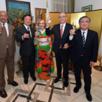 Ambassador of Algeria Mohamed El Amine Bencherif (second from right) and his wife, Amira (center) raise a toast with, from left, Ambassador of Eritrea and Dean of the African Diplomatic Corps Estifanos Afeworki Haile; State Minister for Foreign Affairs Kenji Wakamiya; and Masayuki Sato, representative director, chairman and chief executive officer of JGC Holdings Corporation and chairman of the Japan-Algeria Economic Committee of Keidanren, during a reception to celebrate Algeria\'s national day at the ambassador\'s residence in Tokyo on Dec. 20. | YOSHIAKI MIURA