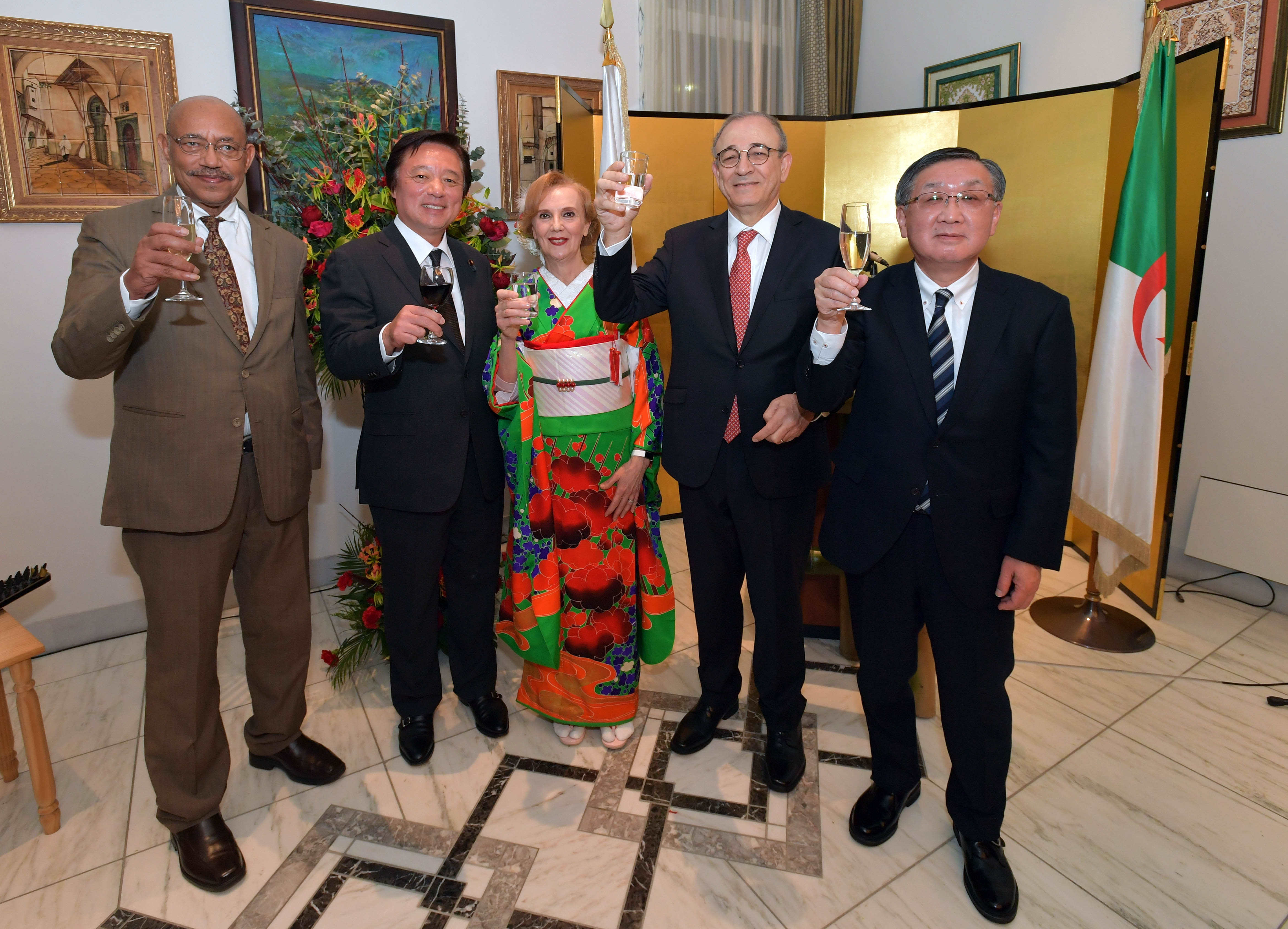 Ambassador of Algeria Mohamed El Amine Bencherif (second from right) and his wife, Amira (center) raise a toast with, from left, Ambassador of Eritrea and Dean of the African Diplomatic Corps Estifanos Afeworki Haile; State Minister for Foreign Affairs Kenji Wakamiya; and Masayuki Sato, representative director, chairman and chief executive officer of JGC Holdings Corporation and chairman of the Japan-Algeria Economic Committee of Keidanren, during a reception to celebrate Algeria's national day at the ambassador's residence in Tokyo on Dec. 20. | YOSHIAKI MIURA