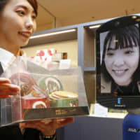 ANA Holdings on Thursday opened what it says is the world\'s first store where customers can shop remotely using a robotic avatar. The robots, standing 1.5 meters tall, will be employed through Dec. 24 at the store in a shopping mall in the Nihonbashi district of Tokyo, in collaboration with Isetan Mitsukoshi Holdings. Using a computer, can control the robots from anywhere in the country and shop for items in the gift store as though they were there. No actual customers will be allowed to physically enter the store. Online registration is required to use the service, said ANA, which plans to introduce as many as 1,000 avatar robots across Japan. | KYODO