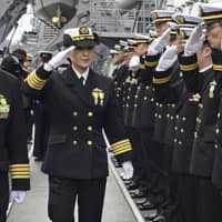Capt. Miho Otani, the first woman to take the helm of a Japanese Aegis-equipped warship, returns salutes on the Maritime Self-Defense Force destroyer Myoko on Monday at the MSDF\'s Maizuru base in Kyoto Prefecture. Otani, 48, became the first woman in the MSDF to captain a training vessel in 2013 and the first to command an MSDF destroyer in 2016. | KYODO