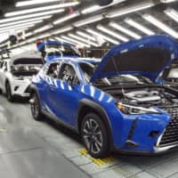 Lexus UX SUVs roll down the production line at a Toyota Motor Corp. plant in Fukuoka Prefecture. | KYODO
