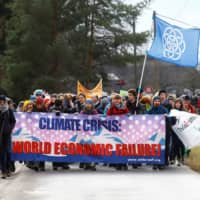 Climate activists start a 30-km hike to the Alpine resort of Klosters, to highlight issues surrounding climate change at the World Economic Forum Davos (WEF), in Landquart, Switzerland, Sunday. | REUTERS