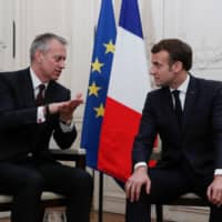 French President Emmanuel Macron (right) meets with James Quincey, chief executive officer of Coca-Cola Co., during the \"Choose France\" summit at the Chateau de Versailles outside Paris on Monday. | BENOIT TESSIER / POOL / VIA AFP-JIJI