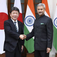 Foreign Minister Toshimitsu Motegi and Indian counterpart Subrahmanyam Jaishankar greet each other ahead of talks in New Delhi on Nov. 30. Japan and India have stepped up cooperation on digital infrastructure. | KYODO