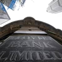 Signage is seen at the entrance to a branch of Lloyd\'s bank in the City of London financial district in London in 2017. | REUTERS