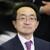 Iwao Nagashima, incoming president and chief executive officer of Mitsubishi UFJ Trust &amp; Banking Corp., reacts at a news conference in Tokyo on Friday. Mitsubishi UFJ Financial Group Inc. has turned to a math expert to help Japan\'s biggest bank forge a path in the digital era. | BLOOMBERG