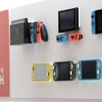 Nintendo Co. Switch and Switch Lite game consoles are displayed at the Nintendo Tokyo store in November. | BLOOMBERG