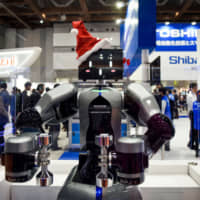 Toshiba Machine\'s humanoid robot is displayed at the International Robot Exhibition in Tokyo in December. | BLOOMBERG