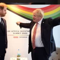 British Prime Minister Boris Johnson gestures at Prince Harry Monday during a bilteral meeting at the U.K.-Africa Investment Summit in London . | AFP-JIJI