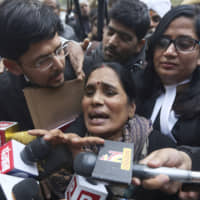 Asha Devi, mother of the victim of the fatal 2012 gang rape on a moving bus, speaks to the media as she leaves a court in New Delhi Tuesday. A death warrant was issued Tuesday for the four men convicted in the 2012 gang rape and murder of a young woman on a New Delhi bus that galvanized protests across India and brought global attention to the country\'s sexual violence epidemic. | AP