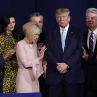 Faith leaders pray with President Donald Trump during a rally for evangelical supporters at the King Jesus International Ministry church in Miami Jan. 3. | AP