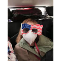 Hermoine Dickey, 8, rides in a car on her way to Wuhan Tiange International Airport for a U.S. evacuation flight Tuesday. The U.S. government is chartering a flight to transport several hundred diplomats, family members, and other Americans out of Wuhan, the central Chinese city at the heart of a new virus outbreak. | PRISCILLA DICKEY / VIA AP