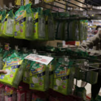 A woman shops for masks at a drug store Tuesday in Tokyo. China on Tuesday reported 25 more deaths from a new viral disease as the U.S. government prepared to evacuate Americans from the city at the center of the outbreak. Japan, Mongolia, France and other governments also were preparing evacuations. | AP