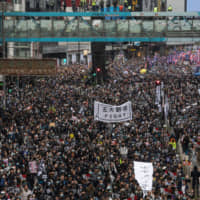 Hong Kongers protest in the Causeway Bay district on Wednesday. | BLOOMBERG