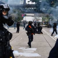 Police fire tear gas to disperse a crowd gathered for a rally at Chater Garden in Hong Kong on Sunday. | AFP-JIJI