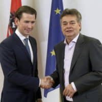 Austrian People\'s Party head Sebastian Kurz (left) shakes hands with Greens leader Werner Kogler during a press conference after finishing coalition negotiations in Vienna on Wednesday. | AP