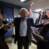 Democratic presidential candidate Sen. Bernie Sanders= speaks with reporters following a forum broadcast on radio in a New Hampshire Public Radio station, Sunday in Concord, New Hampshire. | AP