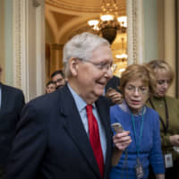 Senate Majority Leader Mitch McConnell is surrounded by reporters after remarks on the floor about the looming impeachment trial of President Donald Trump and Trump\'s order to kill an Iranian general, at the Capitol in Washington Monday. | AP
