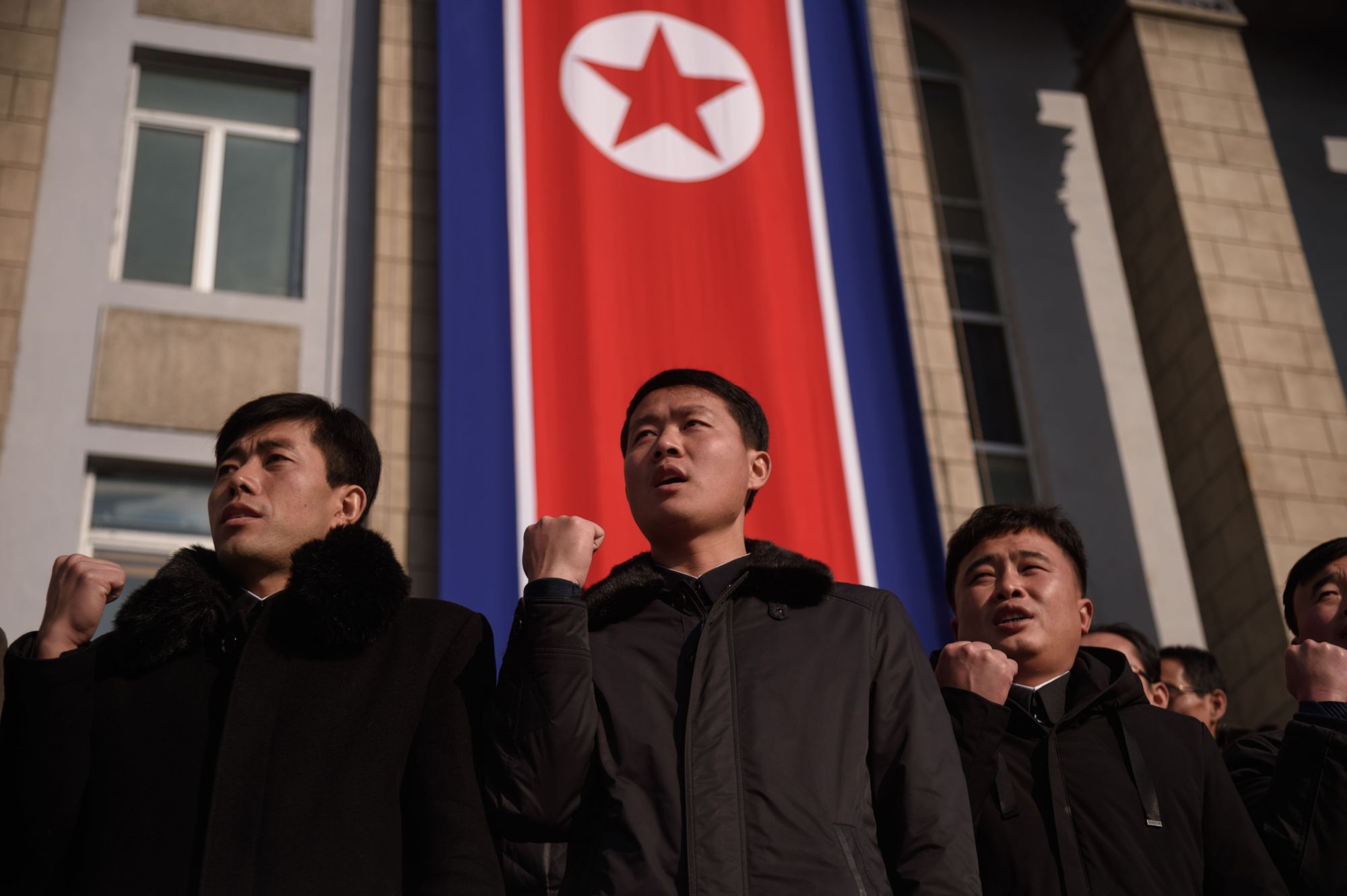 Attendees stand before a North Korean flag during a rally in support of the 5th Plenary Meeting of the 7th Central Committee of the Workers' Party of Korea at Kim Il Sung Square in Pyongyang on Jan. 5. | AFP-JIJI