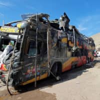 A general view shows the wreckage of a passenger bus that collided with other vehicles and rolled over, leaving several victims, in Arequipa, Peru, Monday. | REUTERS