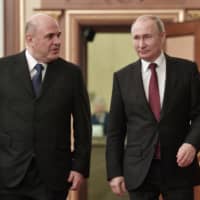 Russian President Vladimir Putin (right) and new Russian Prime Minister Mikhail Mishustin arrive to attend a new cabinet meeting in Moscow Tuesday0. Putin formed his new Cabinet Tuesday, replacing many of its members but keeping his foreign, defense and finance ministers in place. | ALEXEI NIKOLSKY / SPUTNIK / KREMLIN POOL PHOTO / VIA AP