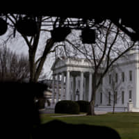 The White House is seen Thursday beyond television equipment in Washington. House Speaker Nancy Pelosi and Senate Majority Leader Mitch McConnell are locked in a stare-down over the terms of President Donald Trump\'s impeachment trial, which carries political risks for both sides if it continues deeper into January. | BLOOMBERG