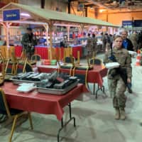 A picture taken Monday during a press tour organized by the U.S.-led coalition fighting the remnants of the Islamic State group shows members the U.S. military walking through the cafeteria inside Ain al-Asad airbase in the western Iraqi province of Anbar. | AFP-JIJI