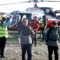 Tourists arrive after a rescue operation from Mount Annapurna base camp, at the airport of Pokhara, some 200 km west of Kathmandu, on Saturaday. Four South Koreans and three Nepalis are missing and about 200 people have been rescued after an avalanche hit trekkers on Annapurna, one of the highest mountains in the Himalayas, officials said. | AFP-JIJI