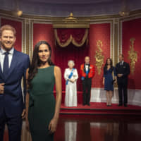 The figures (left) of Britain\'s Prince Harry and Meghan, Duchess of Sussex, are moved from their original positions next to Queen Elizabeth II, Prince Philip and Prince William and Kate, Duchess of Cambridge, at Madame Tussauds in London Thursday. Madame Tussauds moved its figures of Prince Harry and Meghan from its Royal Family set to elsewhere in the attraction. | VICTORIA JONES / PA / VIA AP