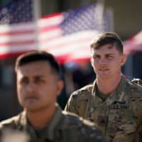 U.S. Army paratroopers assigned to the 1st Brigade Combat Team, 82nd Airborne Division, walk toward an awaiting aircraft prior to departing for the Middle East from Fort Bragg, North Carolina, on Sunday. | REUTERS