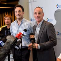 Dr. Mike Catton (center right) and Dr. Julian Druce speak at the Doherty Institute in Melbourne on Wednesday. | AFP-JIJI