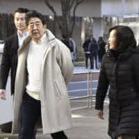 Prime Minister Shinzo Abe and his wife, Akie, stroll through Tokyo\'s Roppongi district on Tuesday. | KYODO