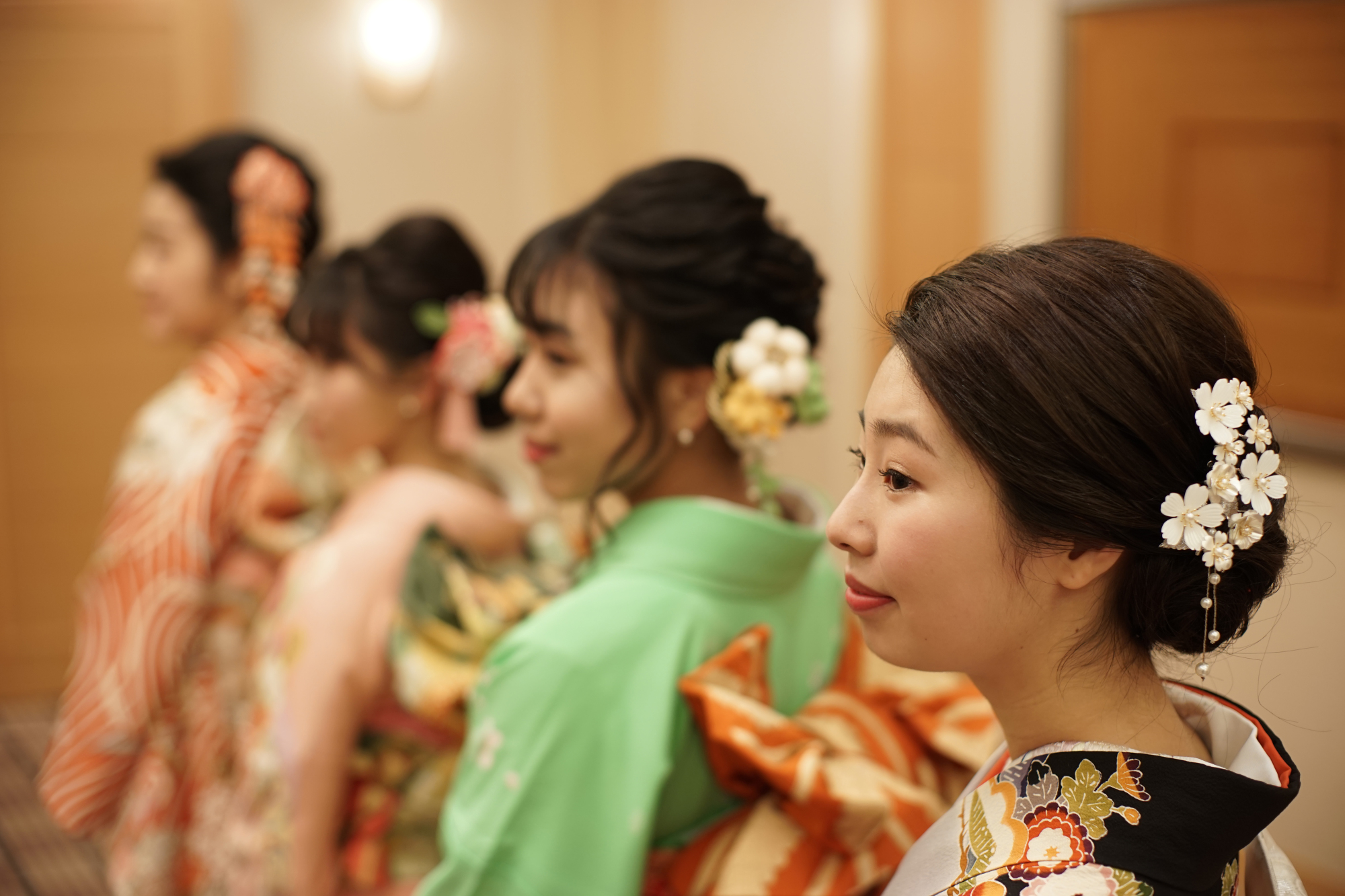 Ayana Fukushima (right) and her friends get ready for a coming-of-age ceremony at the Imperial Hotel in Tokyo on Monday. | RYUSEI TAKAHASHI