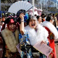 Japanese women wearing kimono attend their Coming of Age Day ceremony at Toshimaen amusement park in Tokyo on Sunday. | REUTERS