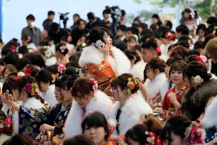 Women draped in traditional kimono gather for their Coming-of-Age Day ceremony at Tokyo Disneyland in Urayasu, Chiba Prefecture, on Monday. | AFP-JIJI