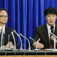Health ministry officials hold a news conference Saturday in Tokyo concerning the third confirmed case of coronavirus infection in Japan. The latest case involves a tourist from the virus-hit central Chinese city of Wuhan. | KYODO